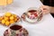 A teenager takes a porcelain cup of tea