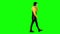 Teenager is talking on the phone walking down the street. Green screen. Side view