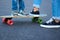 Teenager teaches a child to ride a skateboard and helps him keep balance.