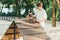 Teenager teaching his cute french bulldog on special playground for dogs. Boy learning commands with red bulldog in the park.