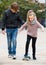 Teenager teaching sister skateboarding