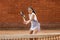 Teenager tennis player girl training court girl racket ball brunette long hair sun portrait learn green summer green