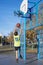 teenager throwing a basketball into the hoop from behind