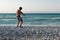 Teenager throwing stones into sea