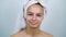 Teenager with towel on head smiling at camera