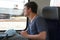 A teenager on train with his rucksack and facial mask prepared for use if needed