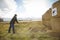 Teenager training knife throwing to the target on meadow