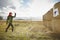 Teenager training knife throwing to the target on meadow