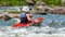 A teenager trains in the art of kayaking. Boat on rough river rapids. The child is skillfully engaged in rafting.