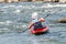 A teenager trains in the art of kayaking. Boat on rough river rapids. The child is skillfully engaged in rafting.