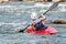 A teenager trains in the art of kayaking. Boat on rough river rapids. The child is skillfully engaged in rafting.