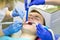 Teenager treating teeth caries or pulpitis in medical office