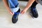 Teenager tying blue laces on the sneakers