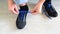 Teenager tying blue laces on the sneakers