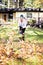 Teenager using leaf blower