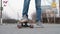 Teenager very close to the camera on a skateboard, close-up of legs