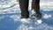 Teenager is wading through snowdrift. Focus to boy legs walk in fresh snow within winter day