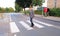 Teenager walking across road while looking at his smartphone