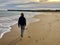 Teenager walking along beach