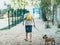 Teenager walking with cute big red french bulldog in the park. Still life, friendship, companionship with a dog, love and care.