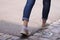 Teenager walks away in rolled up jeans