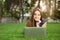 Teenager watching media in a laptop outdoors