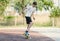 Teenager in white t shirt spends free time training skating in the city park. Practicing skills freestyle, making tricks.