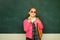 Teenager younf school girl with backpack. Portrait of a teen female student. Funny school girl wearing eyeglasses