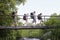 Teenagers With Backpacks Walking On Bridge