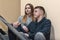 Teenagers boyfriend and girlfriend sit on the steps in block of flats