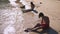 Teenagers, brother and sister making a sand castle on a tropical beach