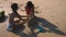 Teenagers, brother and sister making a sand castle on a tropical beach