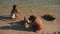 Teenagers, brother and sister making a sand castle on a tropical beach