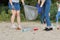 Teenagers cleaning plastic trash in nature, riverbank