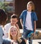 Teenagers communicate in schoolyard