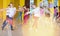 Teenagers dancers practicing dance routine with female choreographer in modern studio