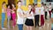 Teenagers dancing waltz in pairs in studio