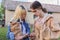 Teenagers with decorative rabbit in hands talking and looking at smartphone