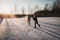 Teenagers frolic on the ice, winter fun girl skating