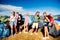 Teenagers in front of tents with backpacks, summer festival