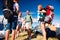 Teenagers in front of tents with backpacks, summer festival