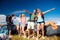 Teenagers in front of tents with backpacks, summer festival