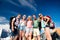 Teenagers in front of tents with backpacks, summer festival