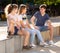 Teenagers gathering outdoors on sunny summer day