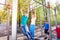 Teenagers hang on horizontal bar at sports ground