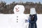 teenagers make a snowman. The concept of active winter recreation.