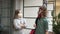 Teenagers in a mask and a respirator are talking standing at a distance from each other. Boy and girl quarantined by