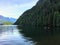 Teenagers paddle boarding and kayaking on a beautiful evening, in a remote inlet in British Columbia.