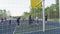 Teenagers play basketball on modern sports ground in park