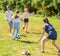 Teenagers play street football with excitement in park